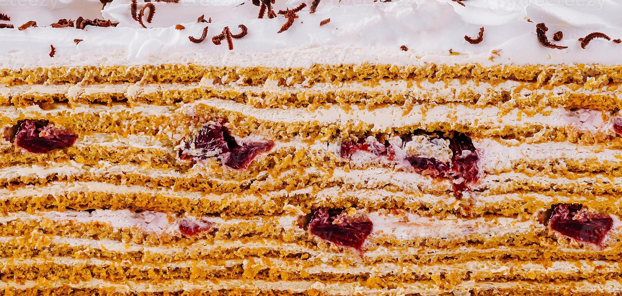 Delicious cake layers showing filling and toppings close up photo