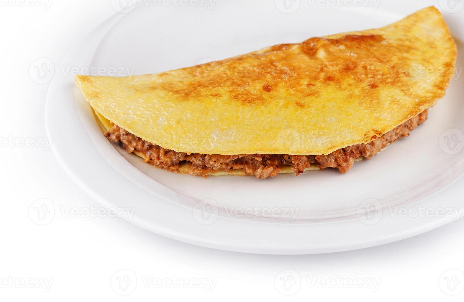 Close up Delicious omelette filled with minced meat lying on a plate photo
