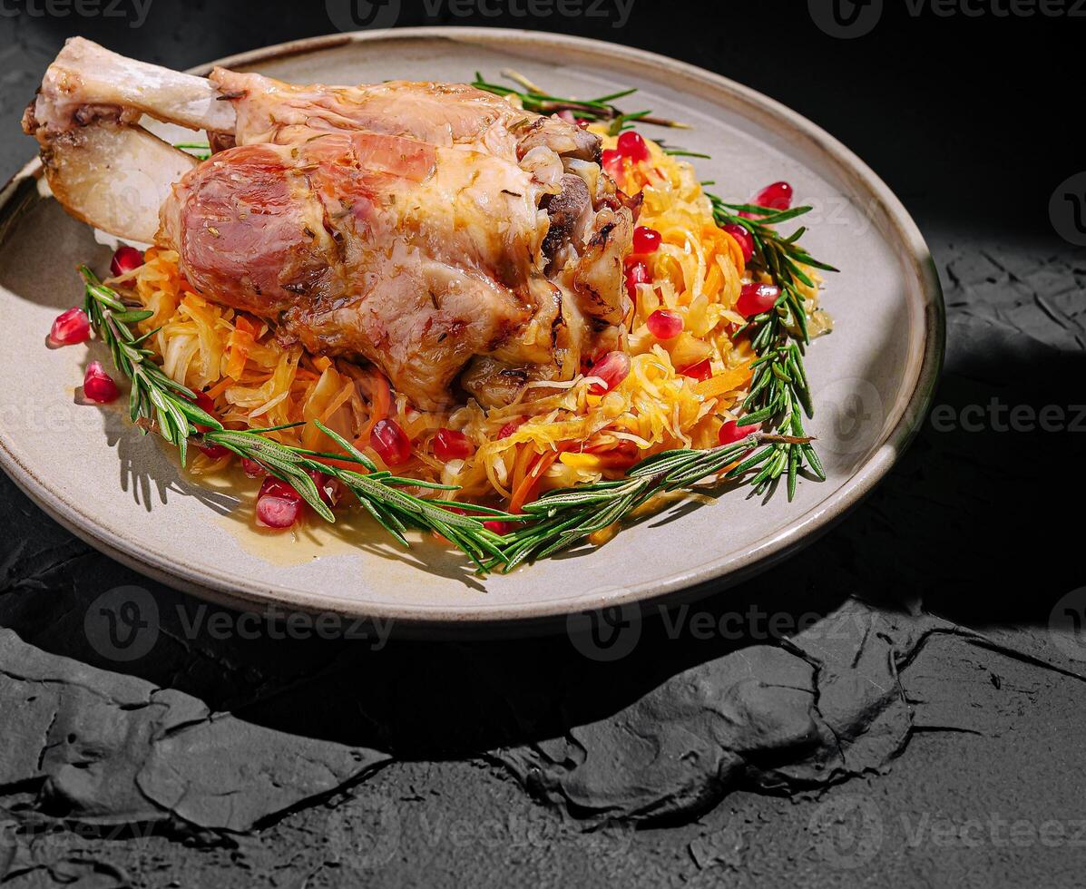 Savory roasted meat served on a plate with vegetables and herbs photo