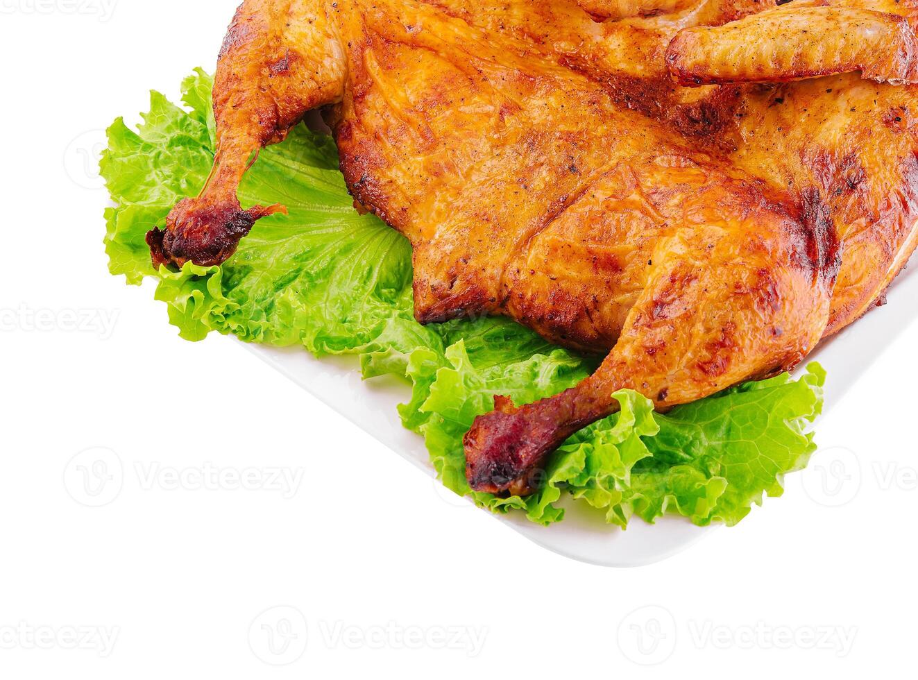 Roasted chicken on fresh lettuce isolated on white photo