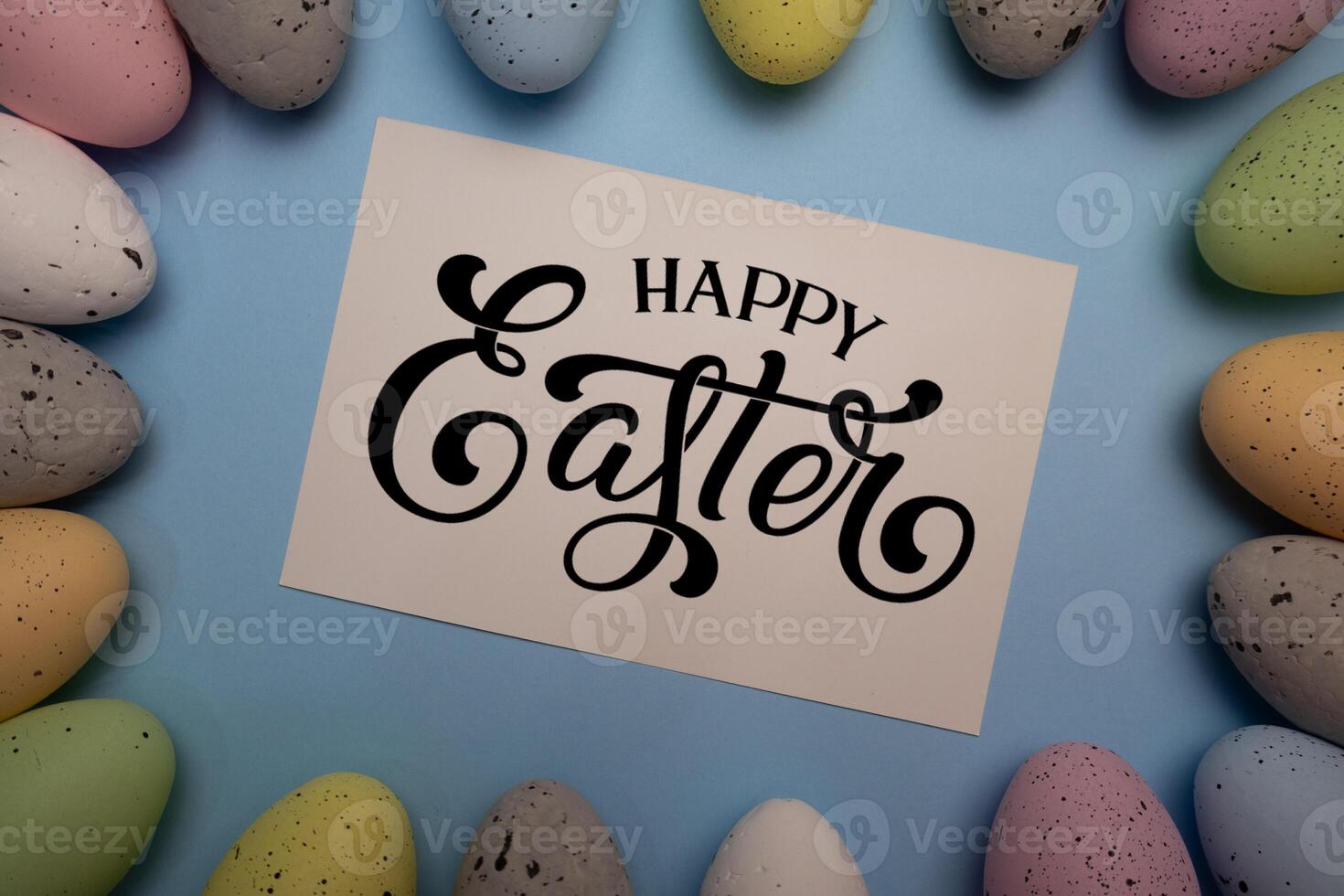 Happy Easter card with colorful eggs frame on pastel blue background photo