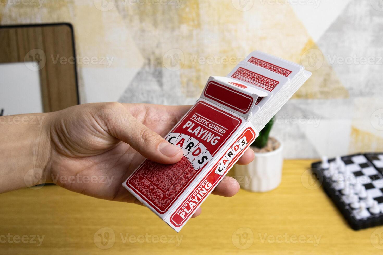 Hand holds new package of playing cards photo