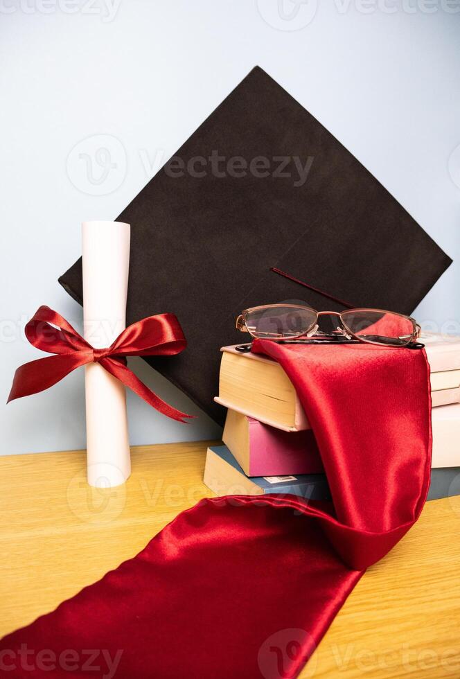 Vertical graduation background with academic hat stole diploma and stack of books photo