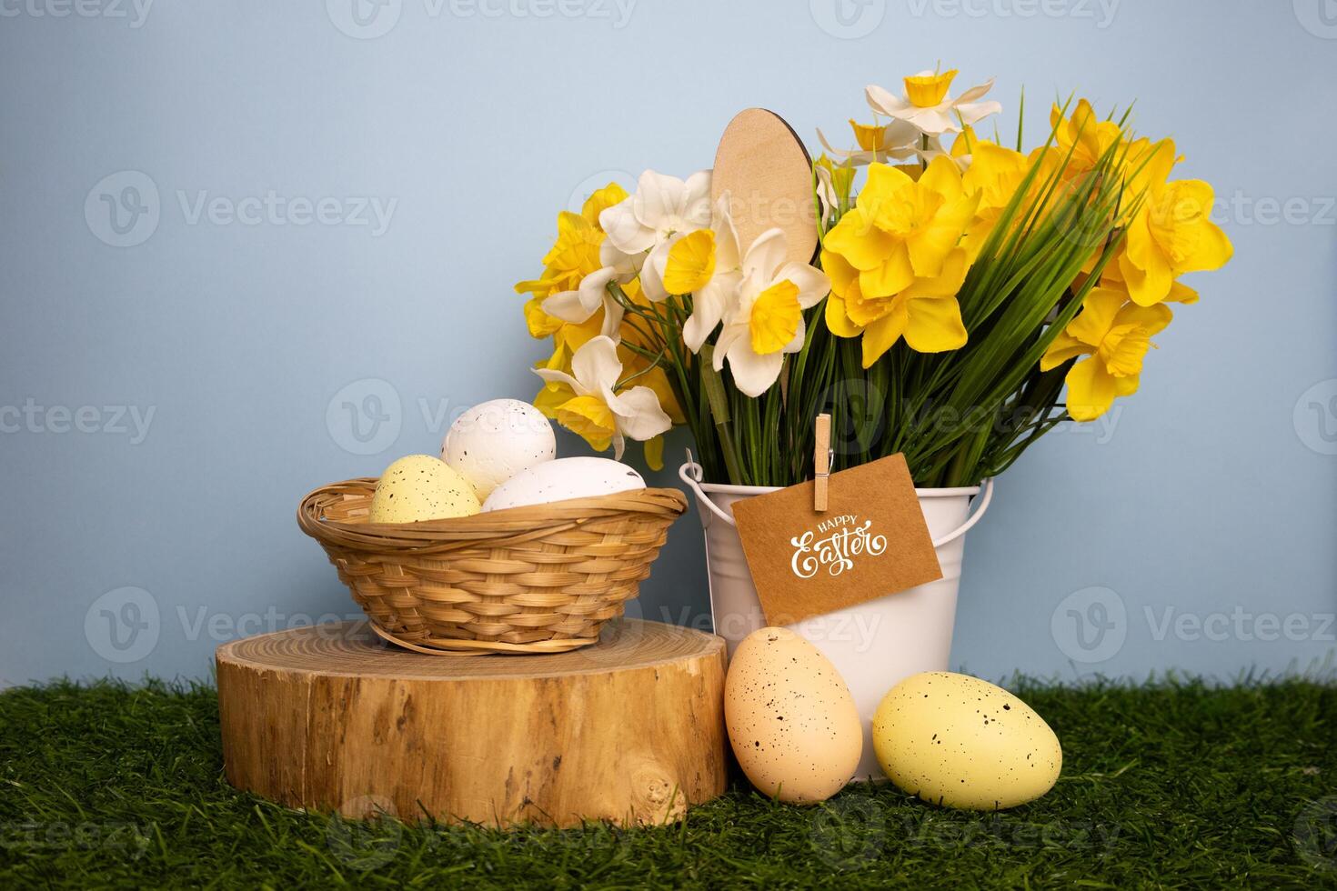 Easter card with daffodil flowers colorful eggs in twigs basket on grass photo