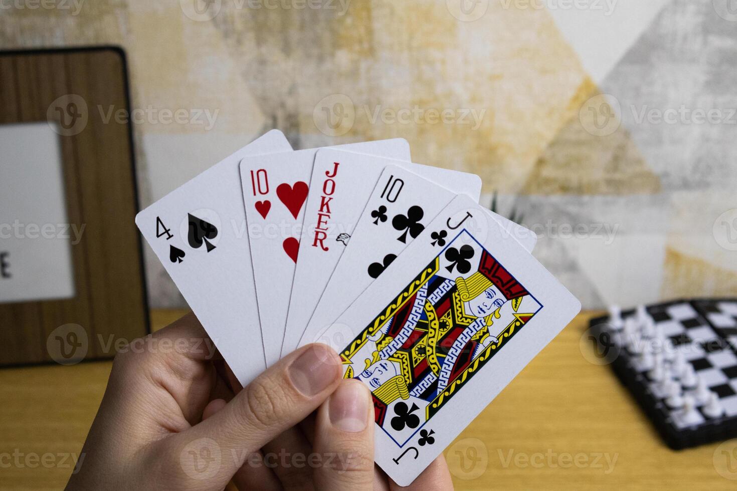 Two hands holds poker playing cards photo