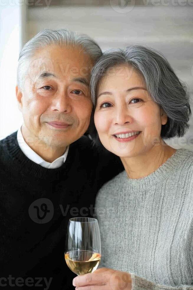 An older couple holding a glass of wine photo