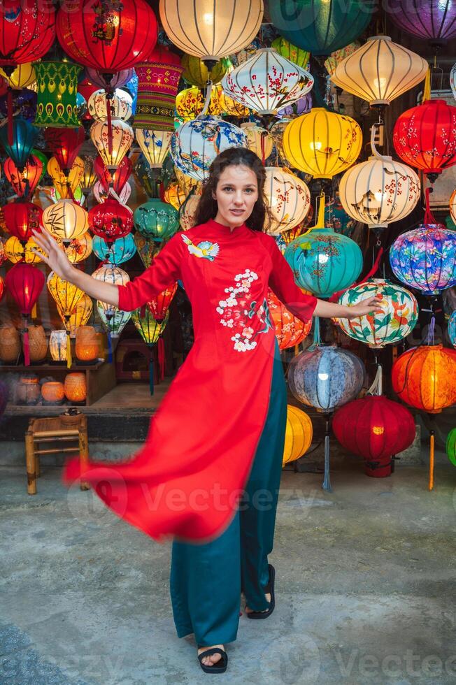 Rear view of Asian traveler woman is enjoy watching lanterns in old town Hoi An photo