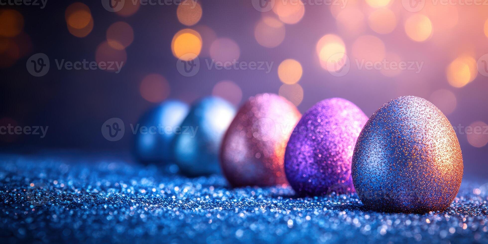 Colorful glitter eggs lined up on a sparkling surface with blurred lights in the background during a festive season photo
