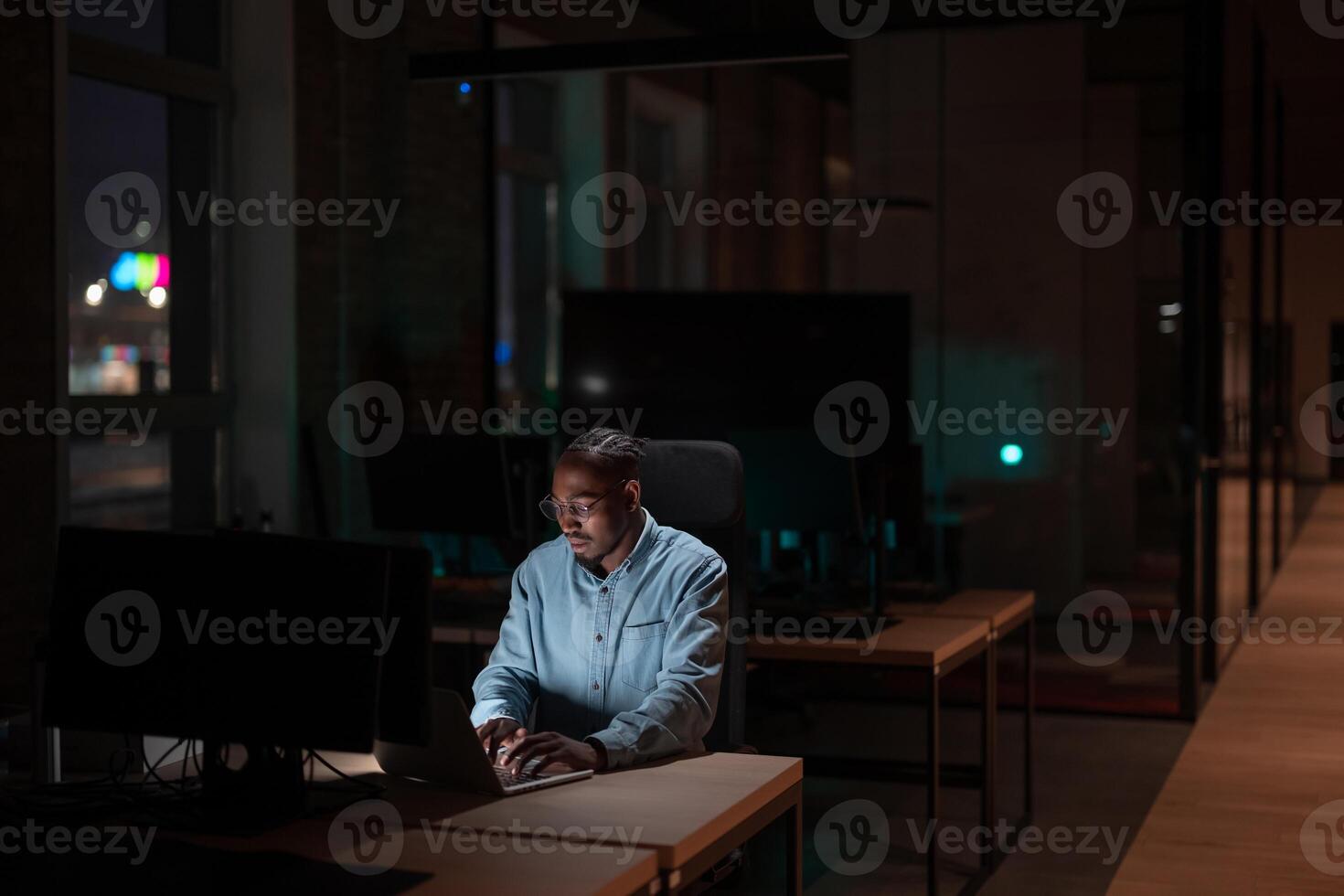 Female businesswoman employee working late in the office, using a laptop while feeling tired and burnt out. Reading, copywriting, editing, and struggling with fatigue and brain fog on a tight deadline photo