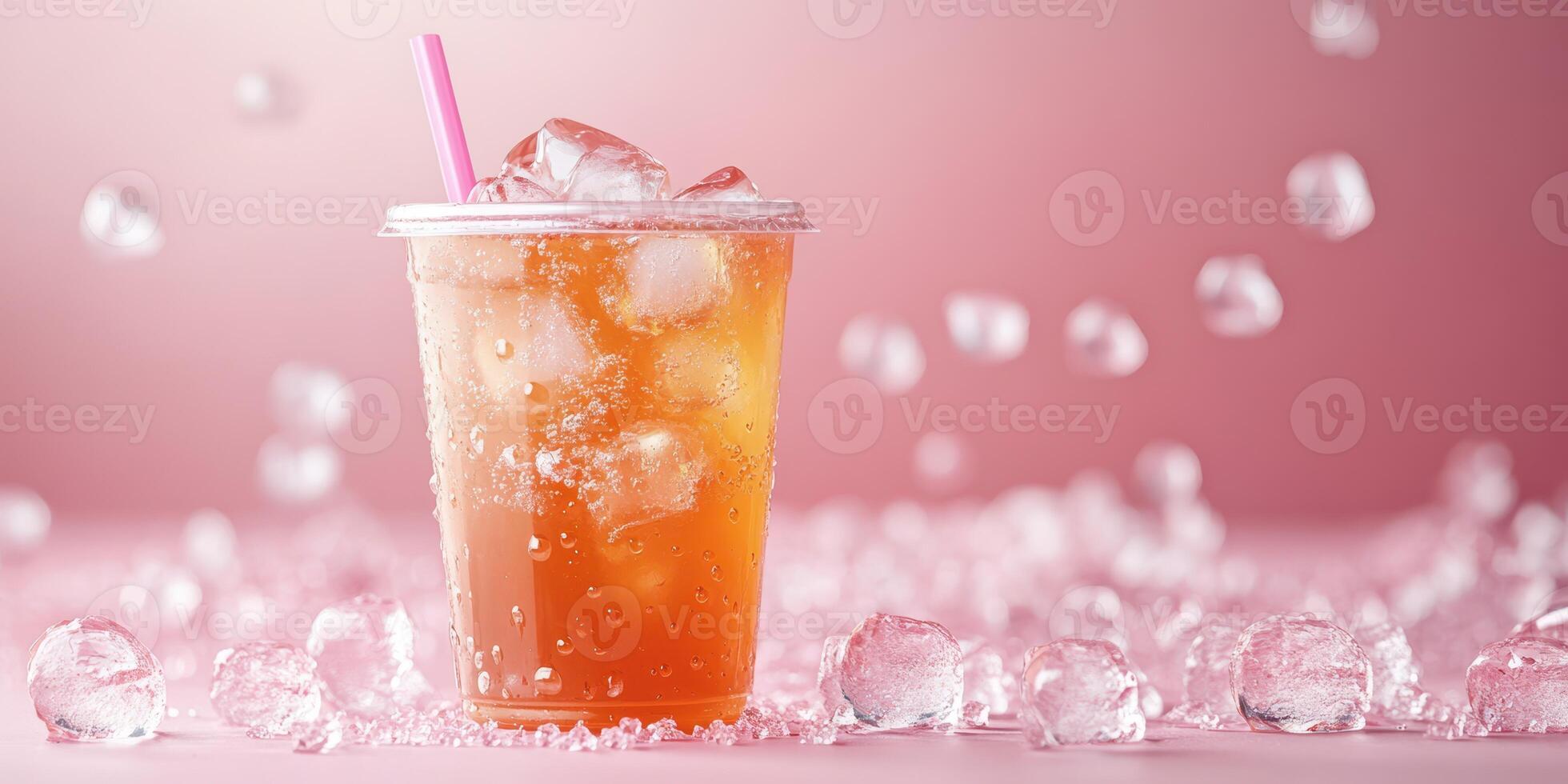 Refreshing iced beverage served in a clear cup with ice on a pink background photo