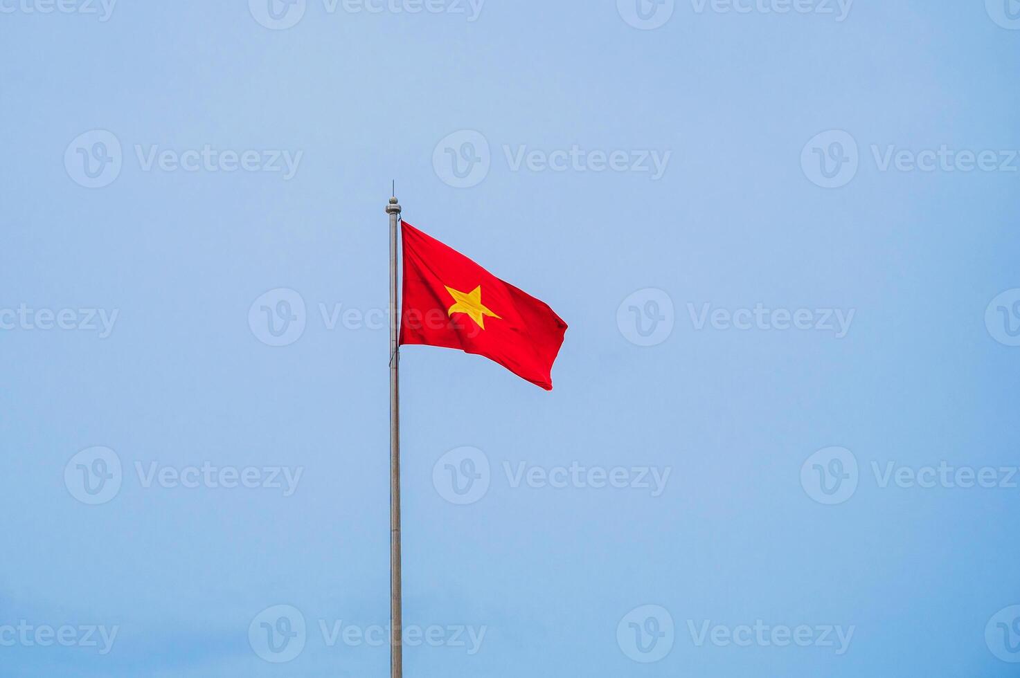 Vietnamese flag waving in the wind with clear blue sky. photo
