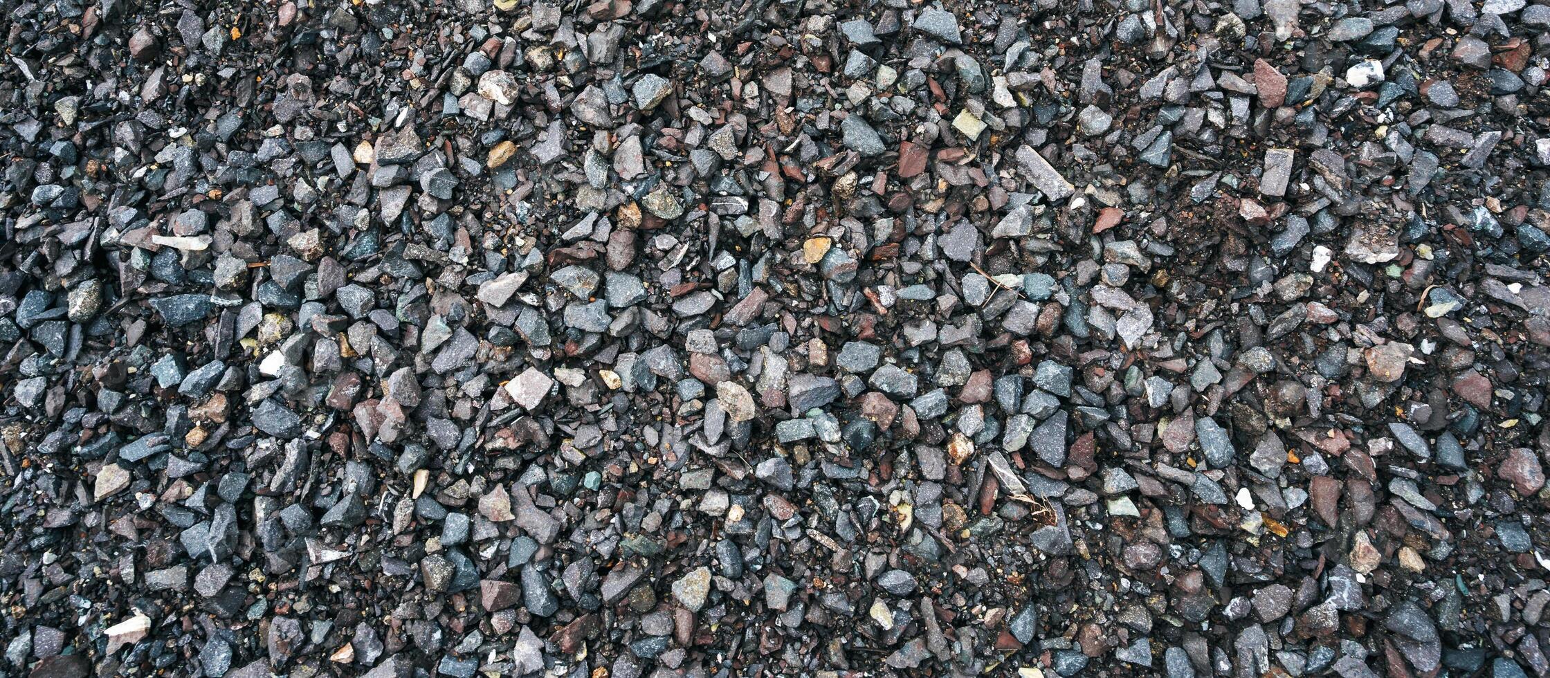 Granite rubble for the background. Building materials, crushed rock. Panoramic background photo