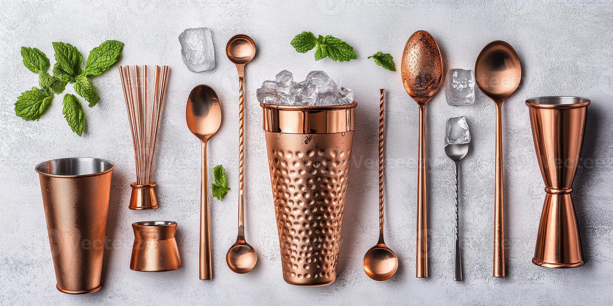 Stylish copper cocktail utensils arranged neatly with mint leaves and ice on a light background photo