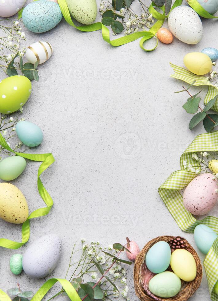 Easter eggs decorating a gray surface with ribbons and flowers photo