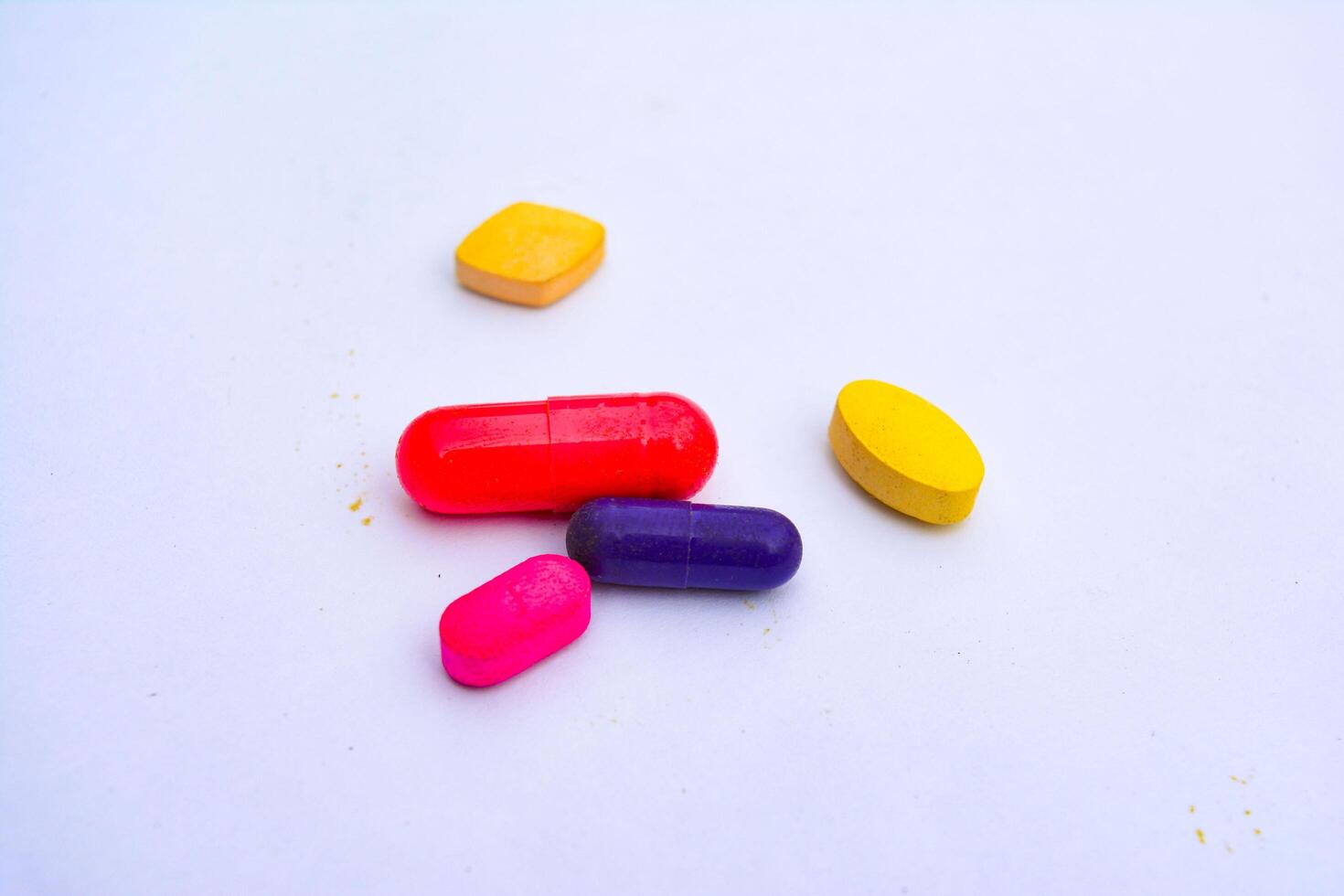 colorful pills on a white surface photo