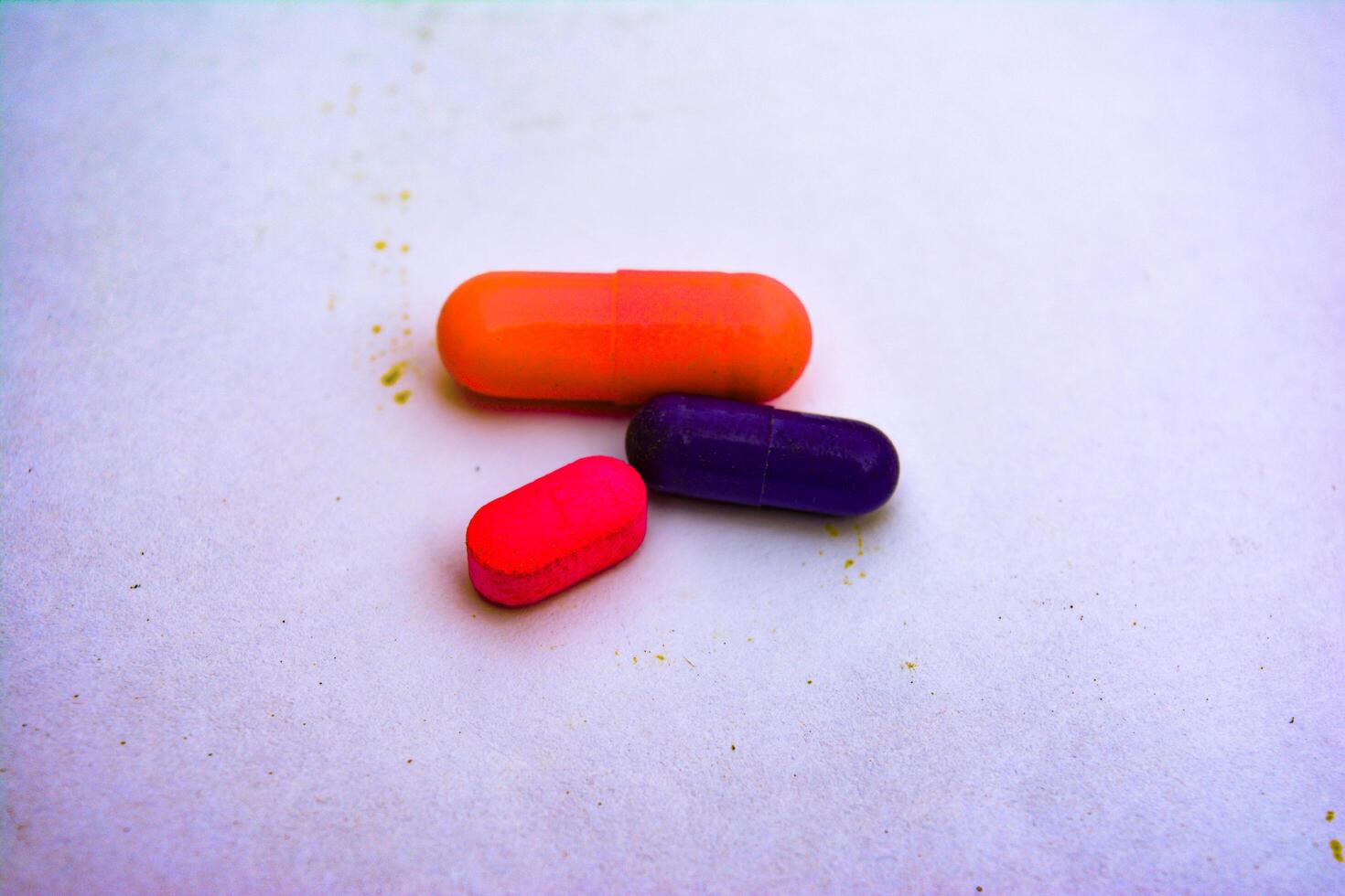 Red and yellow capsules and pills, representing various medications for health and wellness photo