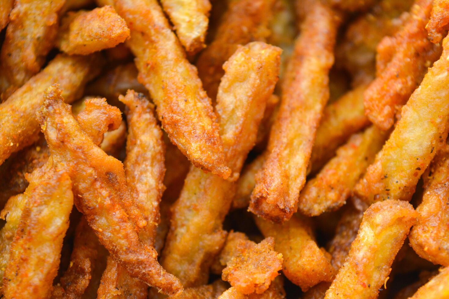French fries on a white plate with a wooden table background, crispy and golden, a delicious and healthy snack photo