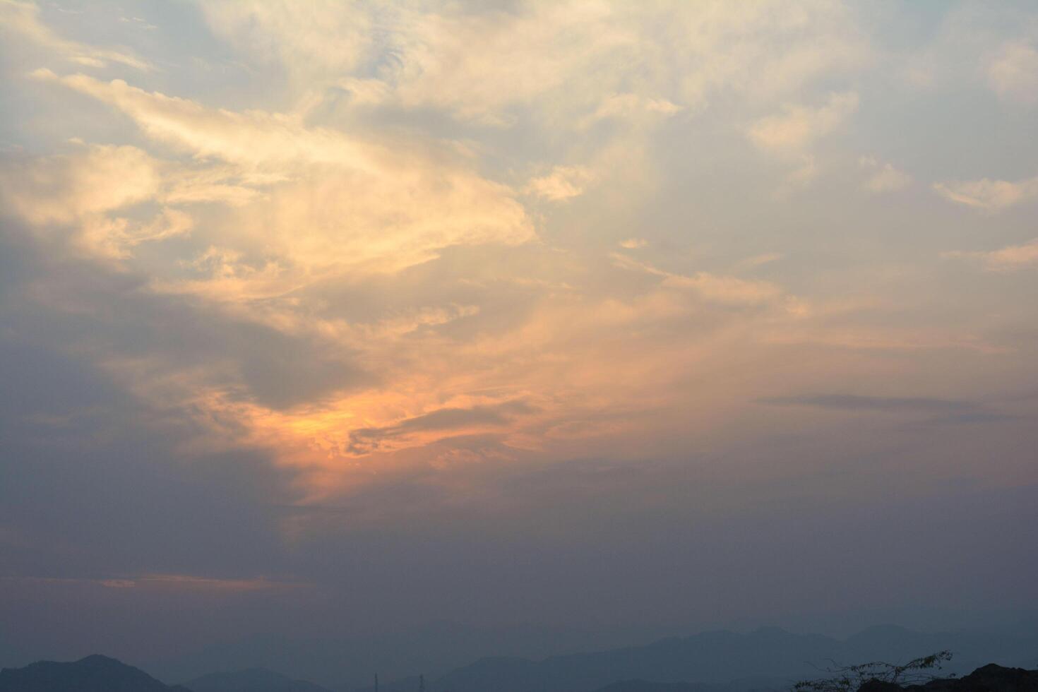 Beautiful sunset sky with vibrant clouds and warm colors of orange, red, and yellow during evening dusk photo