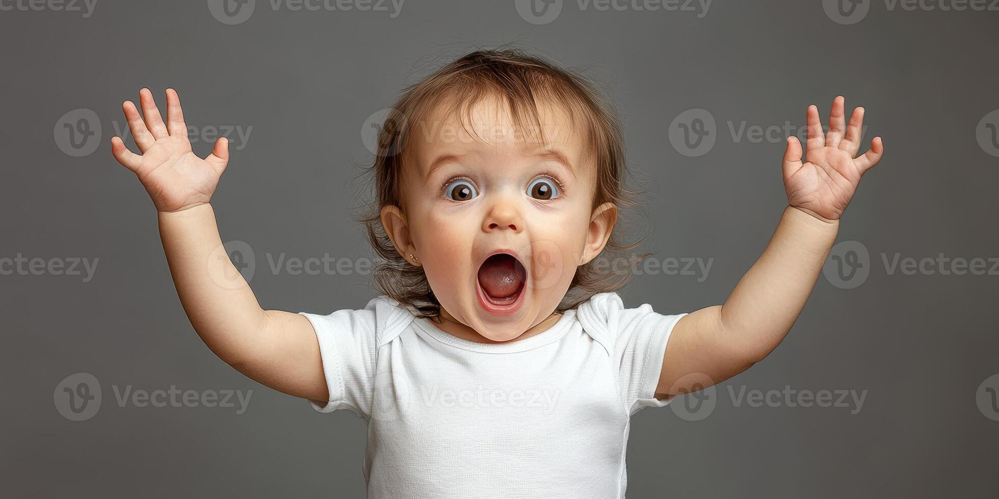 Excited toddler expressing joy with raised hands in a playful indoor setting photo