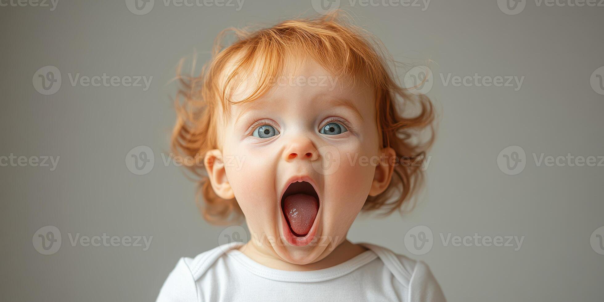 Excited toddler with curly hair expresses joy and surprise in a bright and inviting interior setting photo
