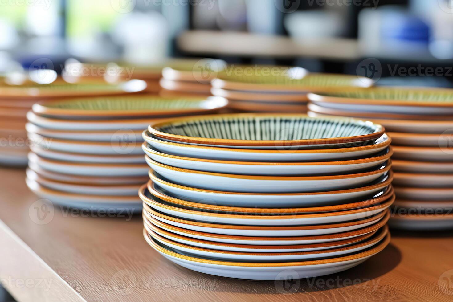 Handmade ceramic plates with artisanal glazes stacked neatly, showcasing unique designs and colors. Perfect for dining and decoration photo