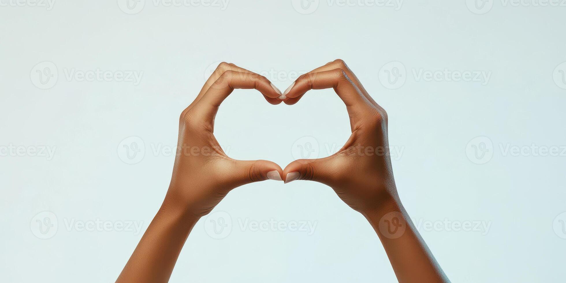 Hands forming a heart shape against a soft background conveying love and connection photo