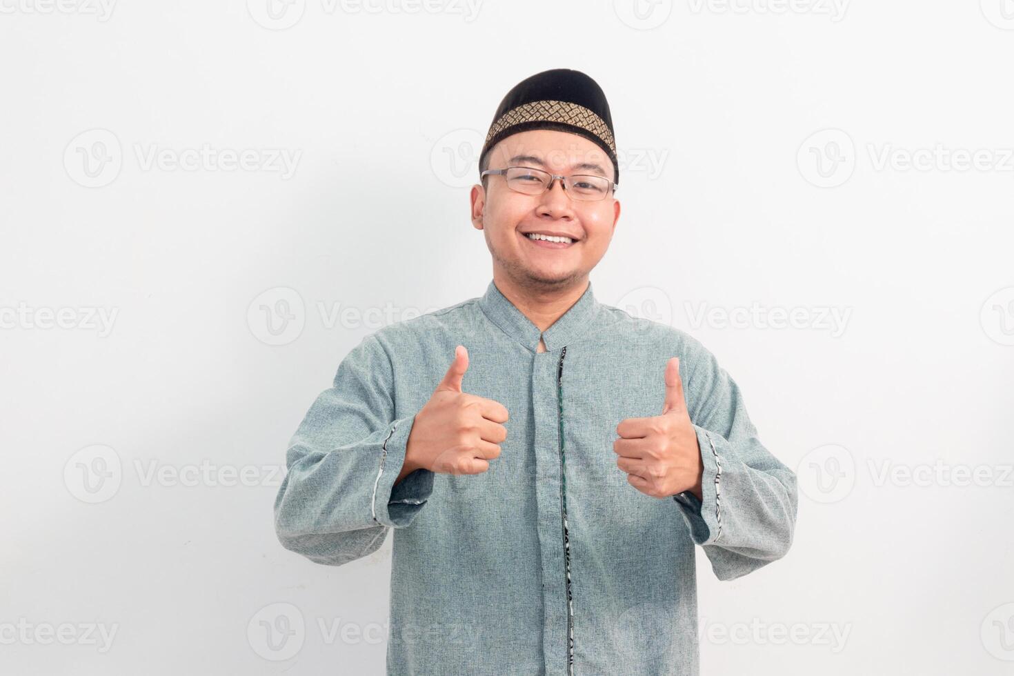 Asian Muslim man doing ok hand thumb up in Ramadan Eid Al Fitr and eid adha days celebration isolated white background. Islamic celebration concept. photo