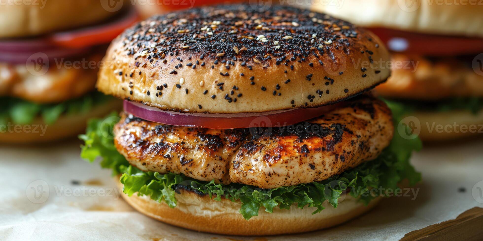 Grilled chicken burger with fresh vegetables served on a toasted sesame seed bun photo