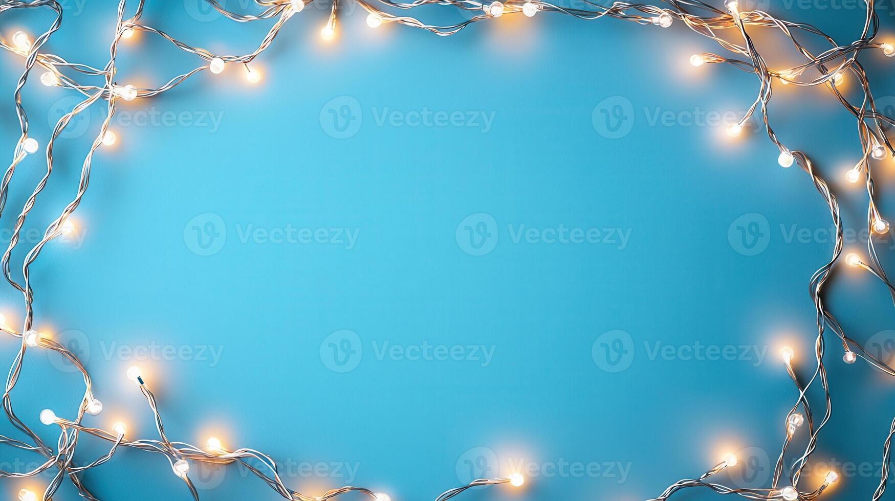 Christmas lights creating a glowing frame on a blue backdrop, perfect for holiday season greetings and festive designs with copy space photo