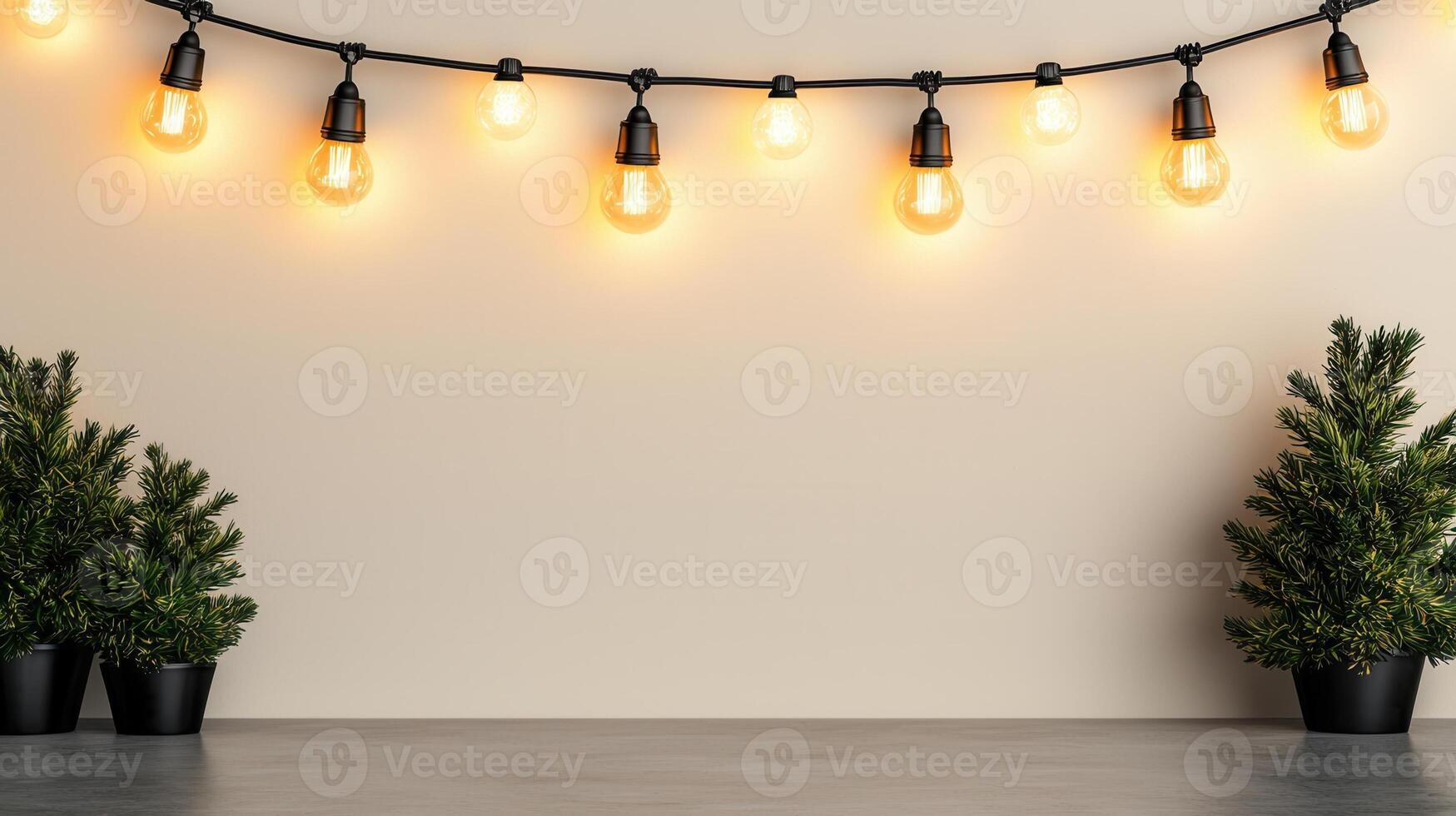 Christmas light bulbs hanging above gray tabletop with small potted pine tree creating warm holiday atmosphere background Copy space for text photo