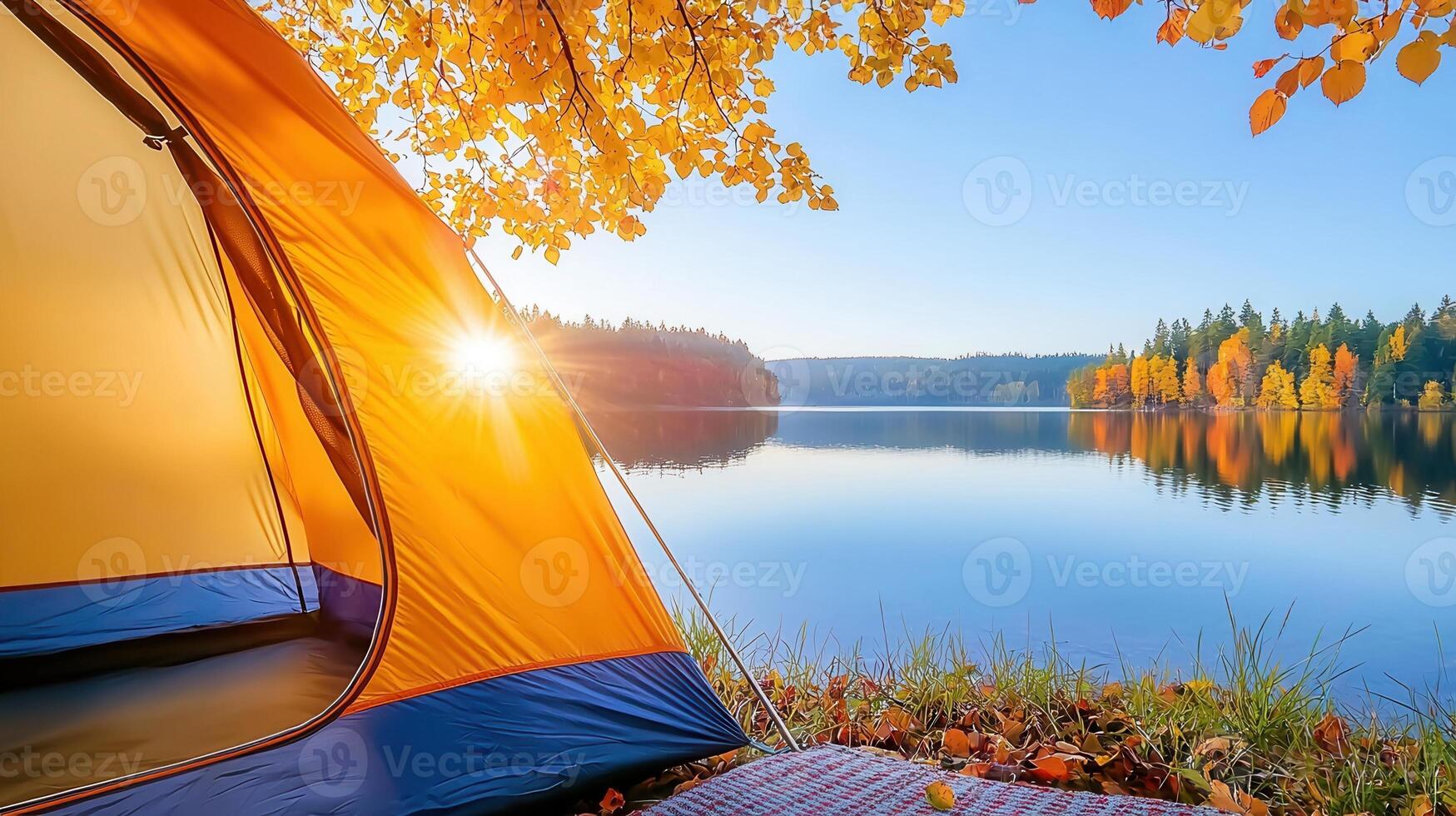 Cozy camping scene with tent and bag by a tranquil lake on a foggy autumn morning, surrounded by colorful fall foliage background photo