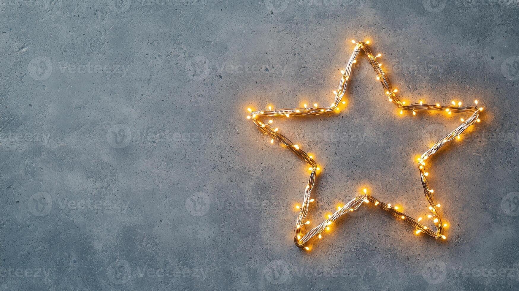 Christmas lights forming a bright star shape decoration on a pale gray background, perfect for holiday season greeting card or website banner Copy space for text photo