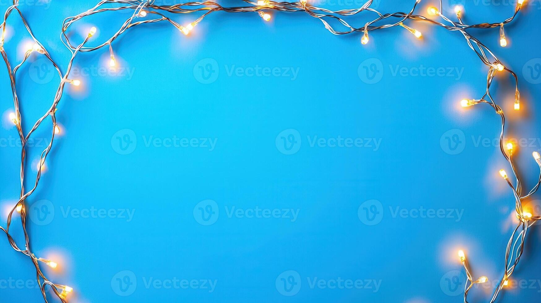 Christmas lights creating a glowing frame on a blue backdrop, perfect for holiday season greetings and festive designs with copy space photo