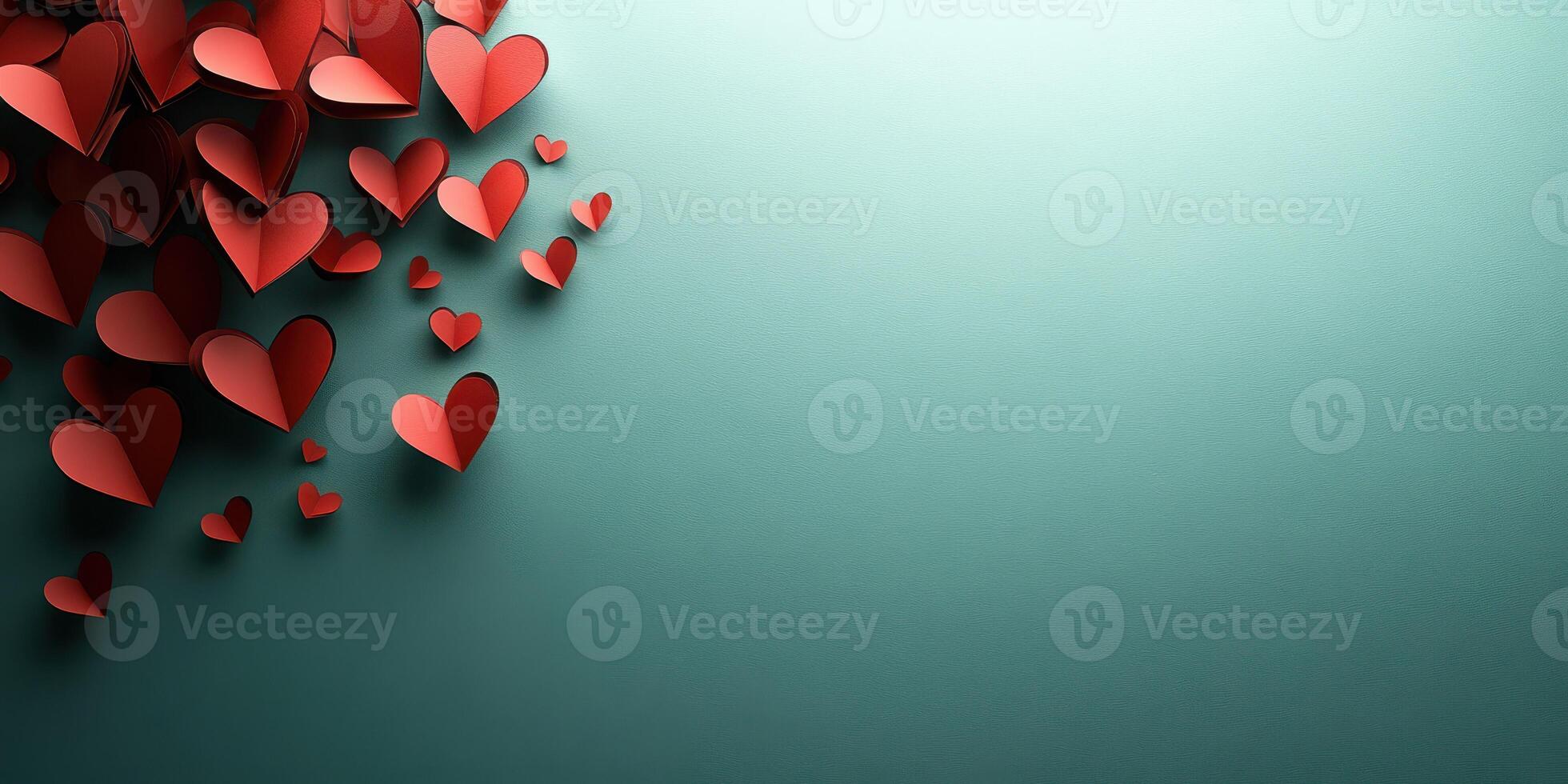 Decorative red paper hearts arranged creatively on a soft teal background for celebrations and romantic occasions photo