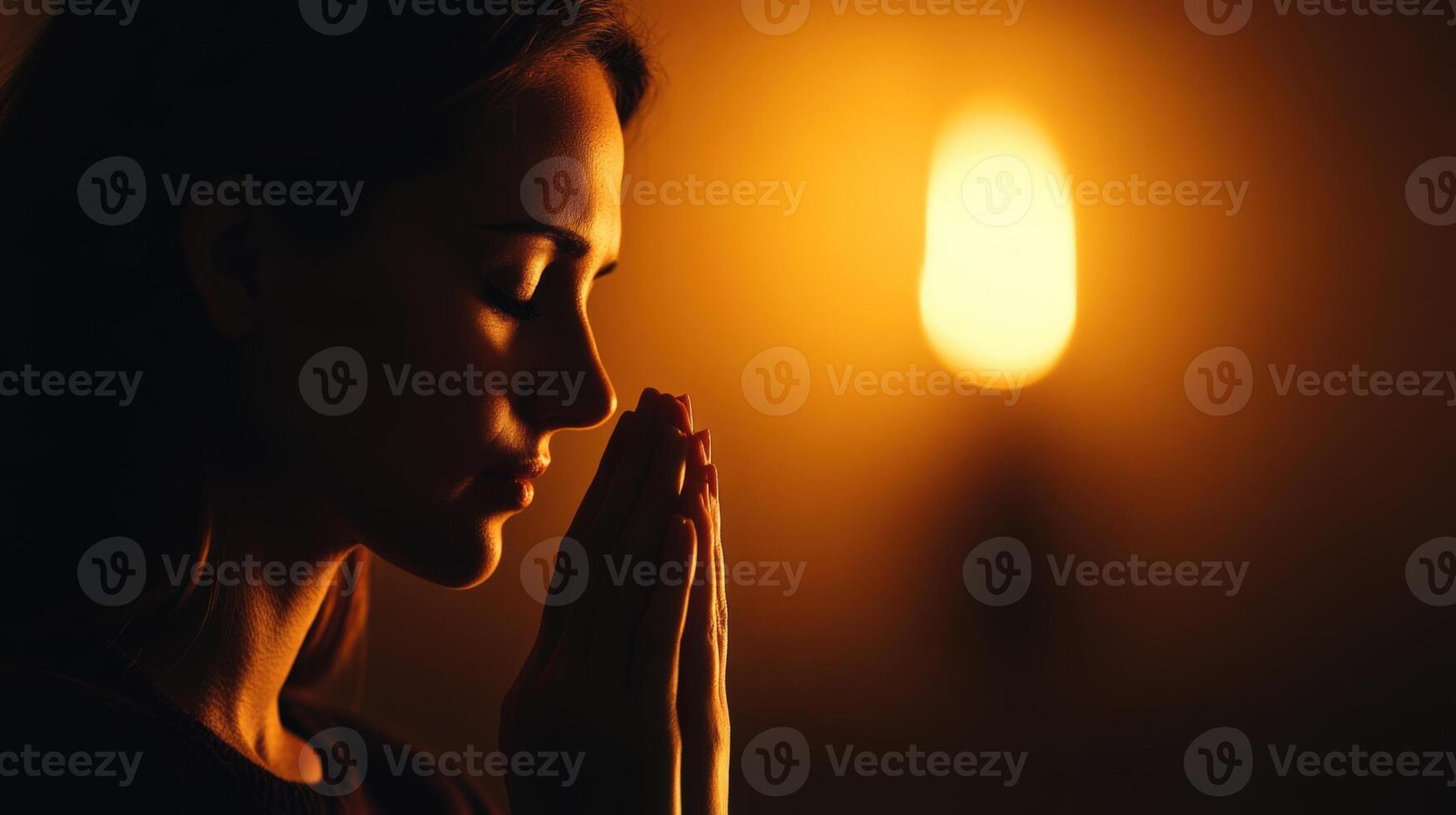 Devout Praying Christian Woman, In Humble Reverence To God. With Hands Folded She Looks Upwards Before Closing Eyes. Seeking Guidance and Strength to Live a Life in Accordance with The Bible photo
