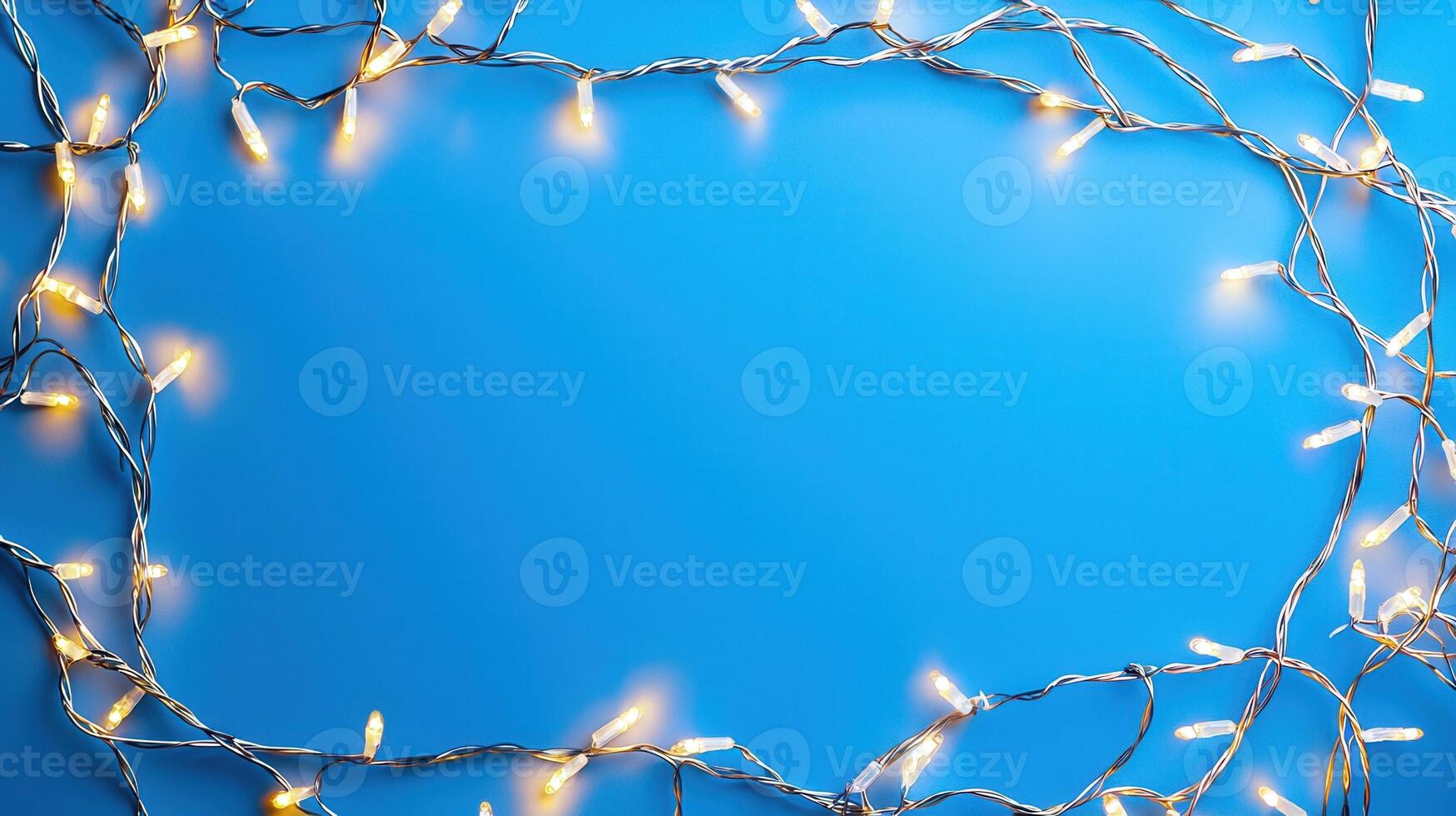 Christmas lights creating a glowing frame on a blue backdrop, perfect for holiday season greetings and festive designs with copy space photo