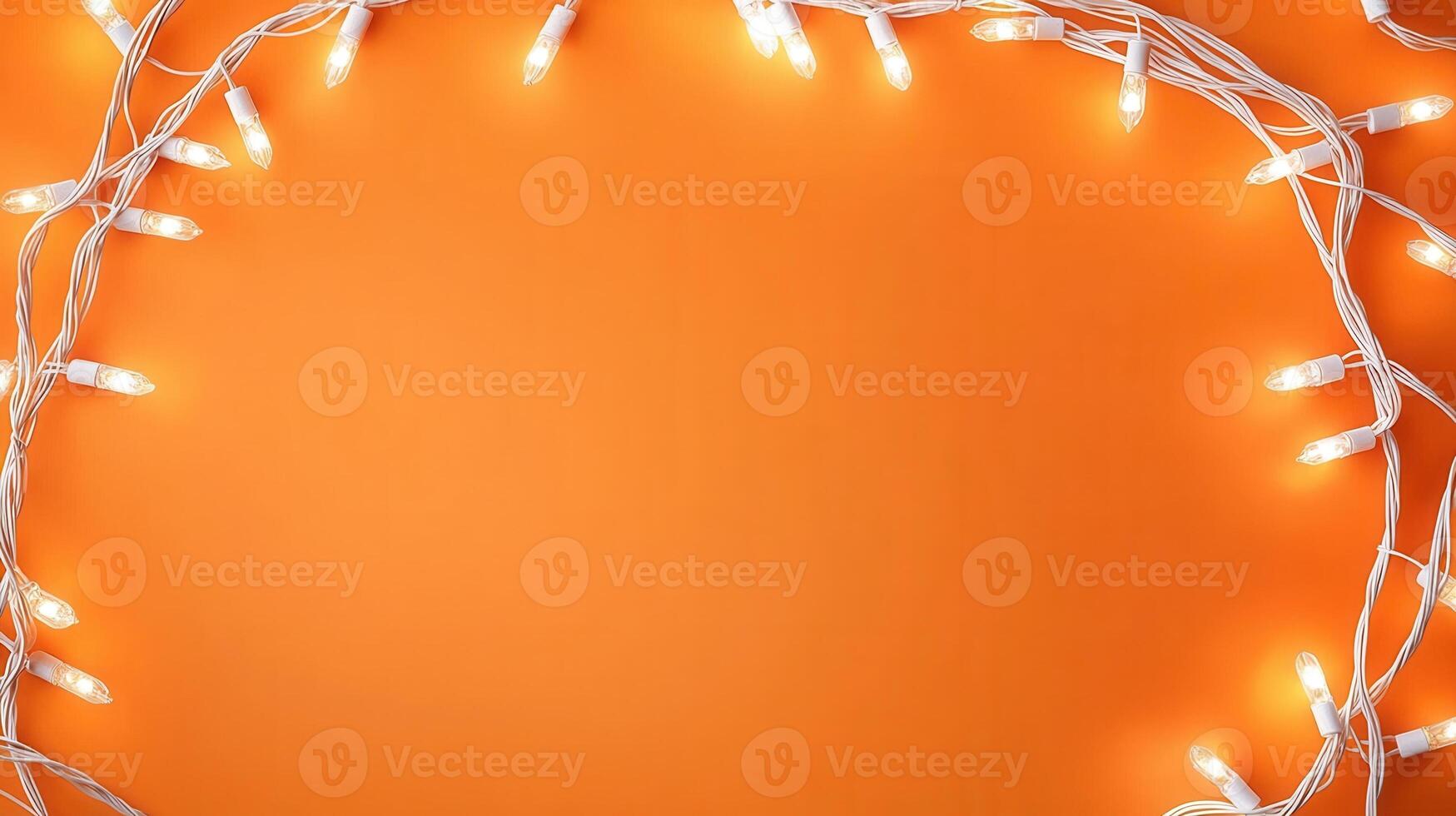 Christmas lights creating a glowing frame on a orange backdrop, perfect for holiday season greetings and festive designs with copy space photo