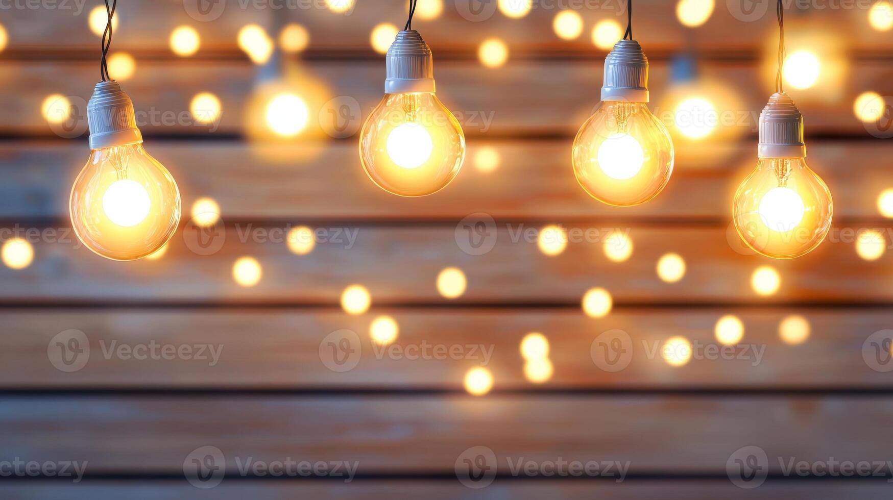 Glowing light bulbs suspended against blurred wooden surface, producing warm ambiance with soft bokeh illumination Copy space for text photo