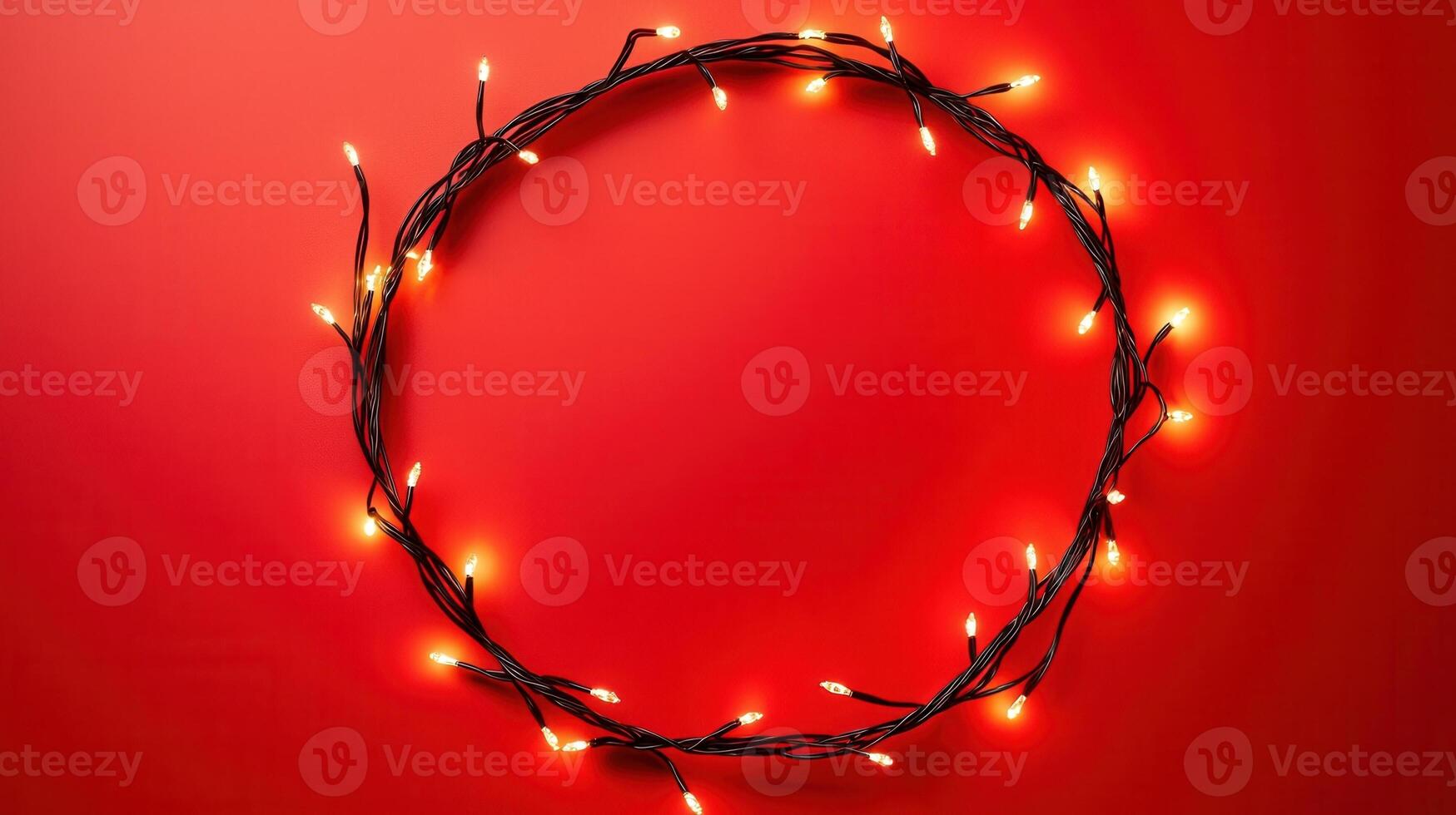 Christmas lights illuminating white creating oval frame on light red background, perfect for winter holidays greeting card photo