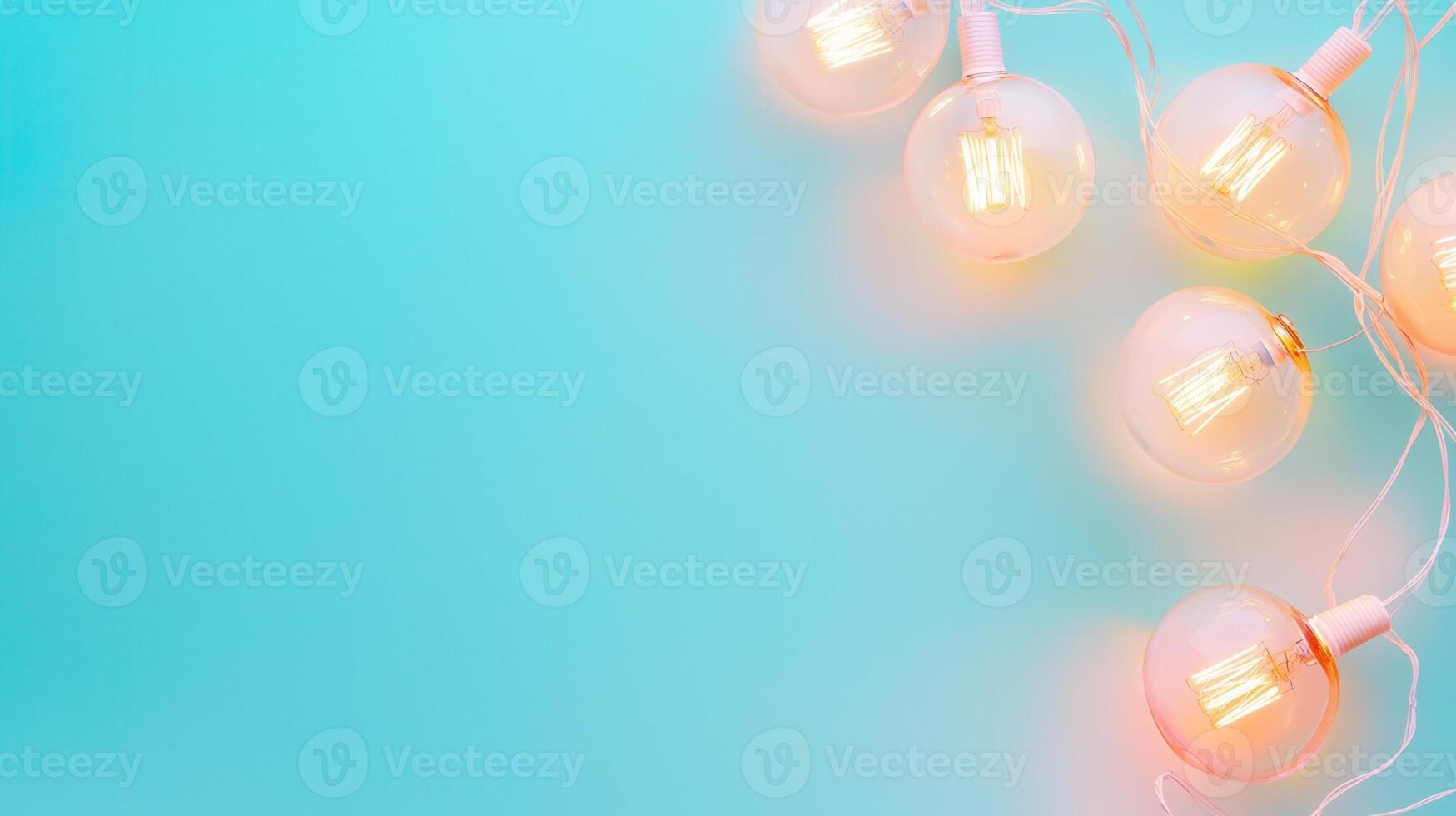 Glowing string lights hanging against turquoise background, casting soft warm illumination with open negative space for creative design placement Copy space for text photo
