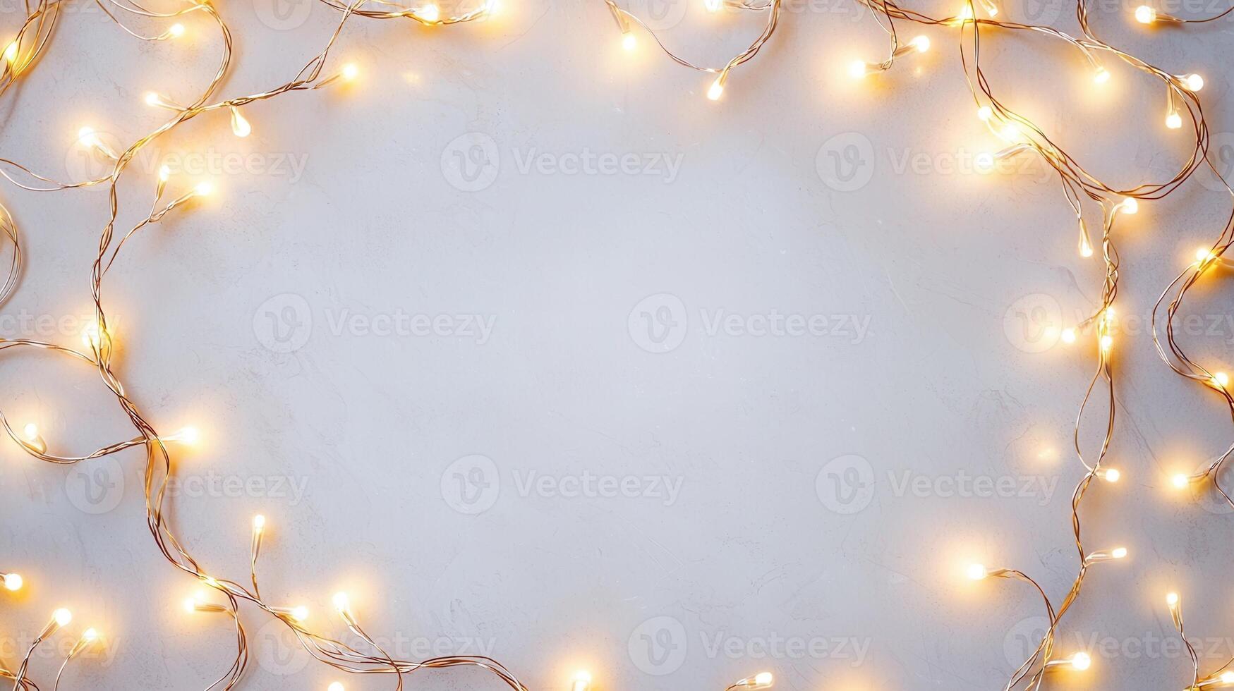 Christmas lights illuminating white creating frame on light blue background, perfect for winter holidays greeting card photo