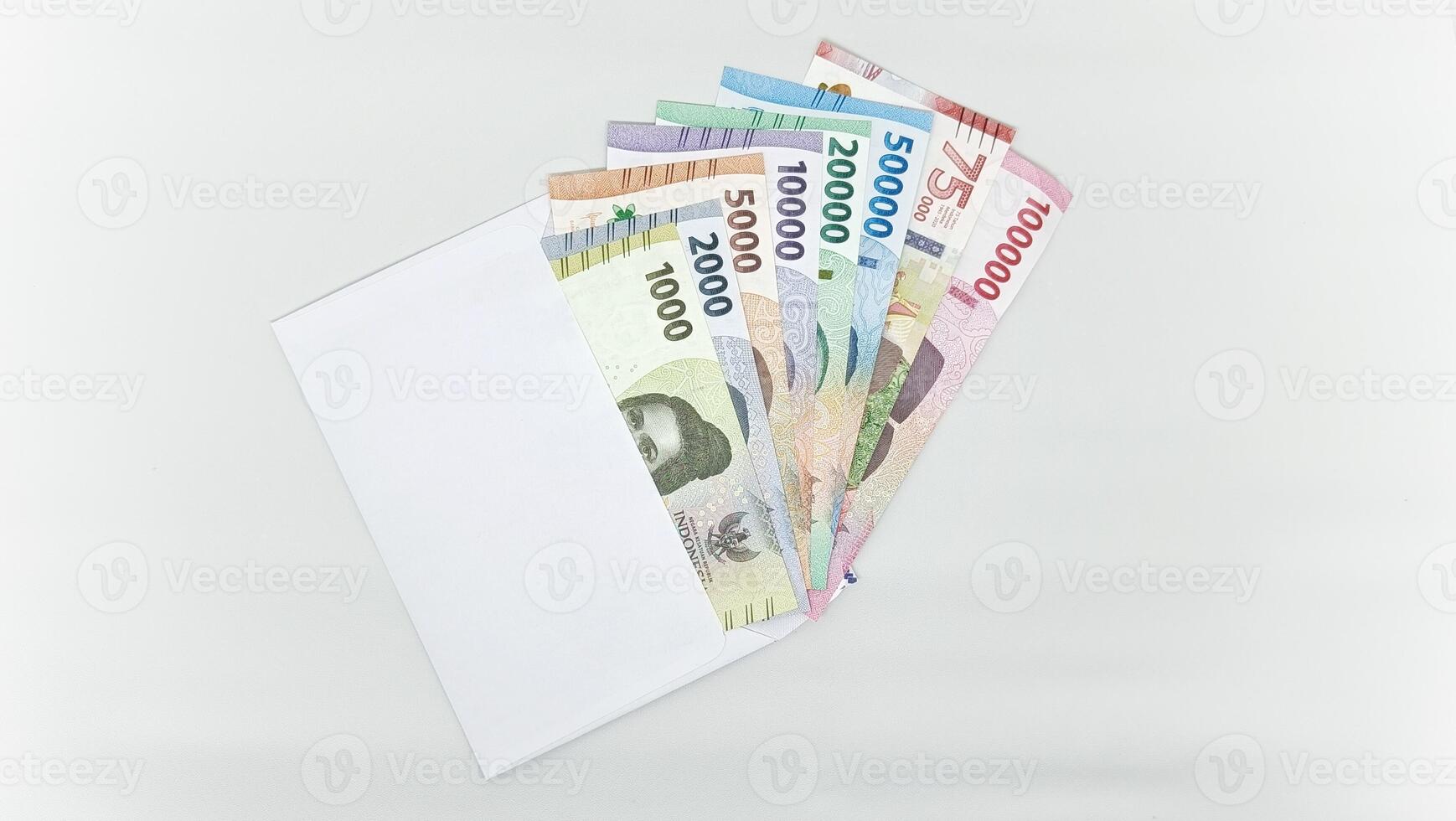 Indonesian banknotes in white envelope. Collection of banknotes in all denominations photo