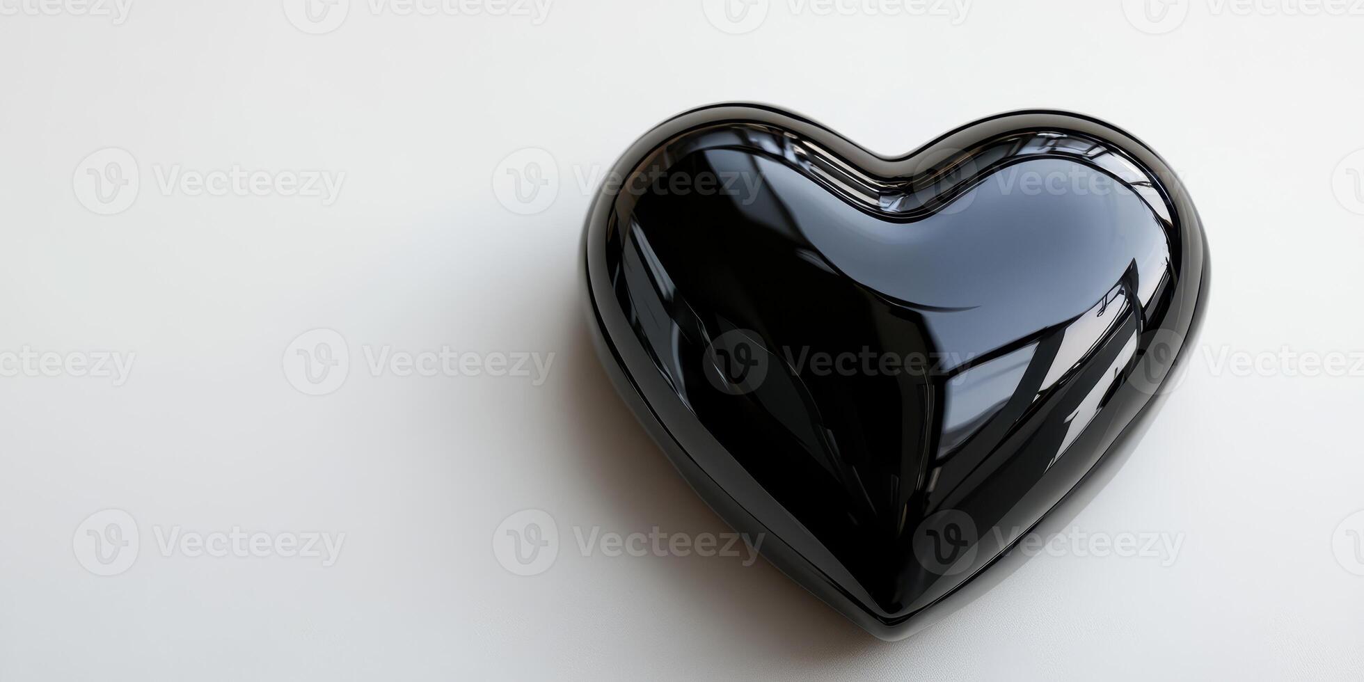Heart-shaped black object placed on a light surface with reflections from nearby windows captured in an indoor setting photo