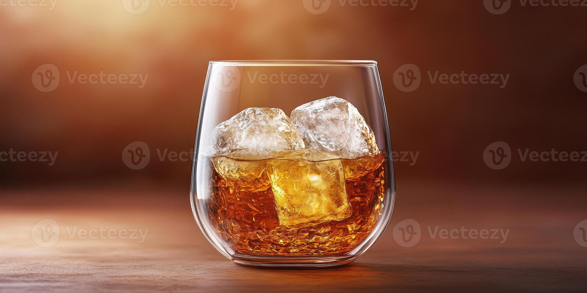 Whiskey served on the rocks in a clear glass with ice cubes and a blurred warm background photo