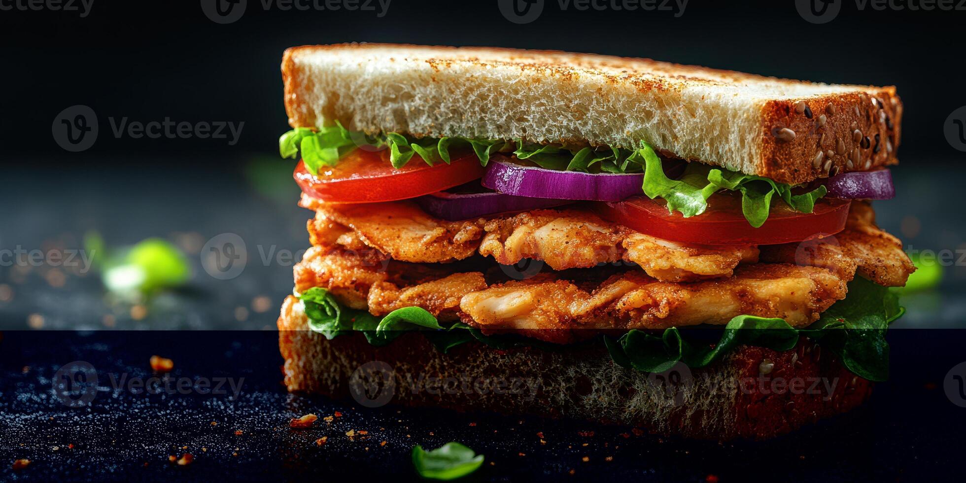 Fresh chicken sandwich stacked with lettuce, tomato, and onion on whole grain bread photo