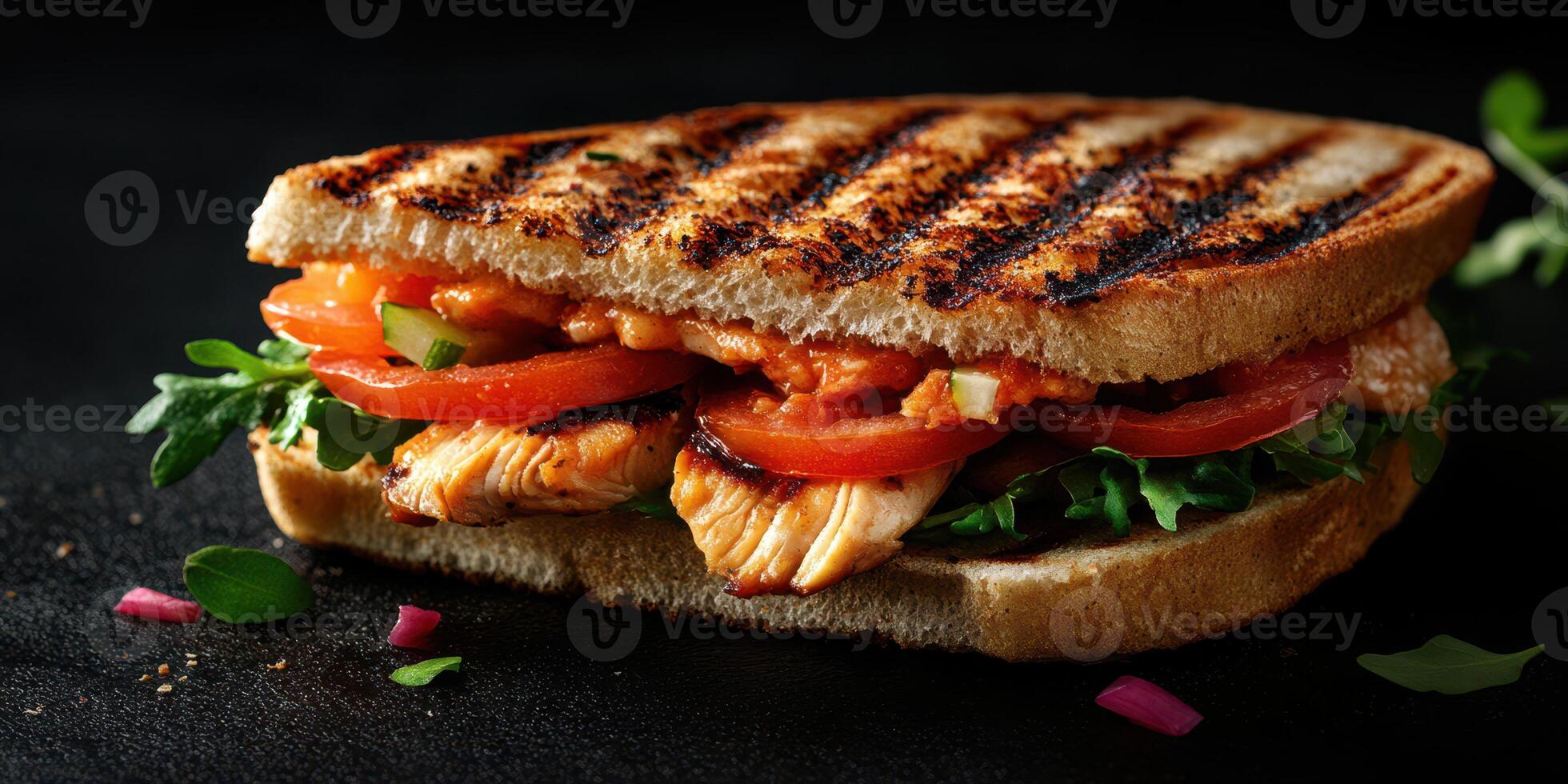 Grilled chicken sandwich with fresh vegetables served on toasted whole grain bread photo