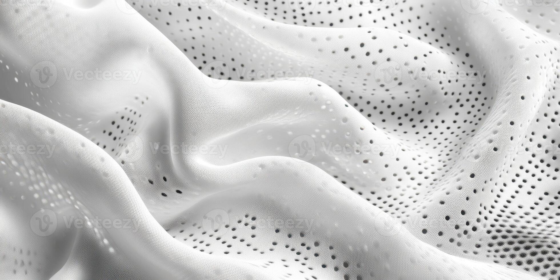 Soft white fabric with subtle polka dots displaying gentle folds and textures in natural light photo