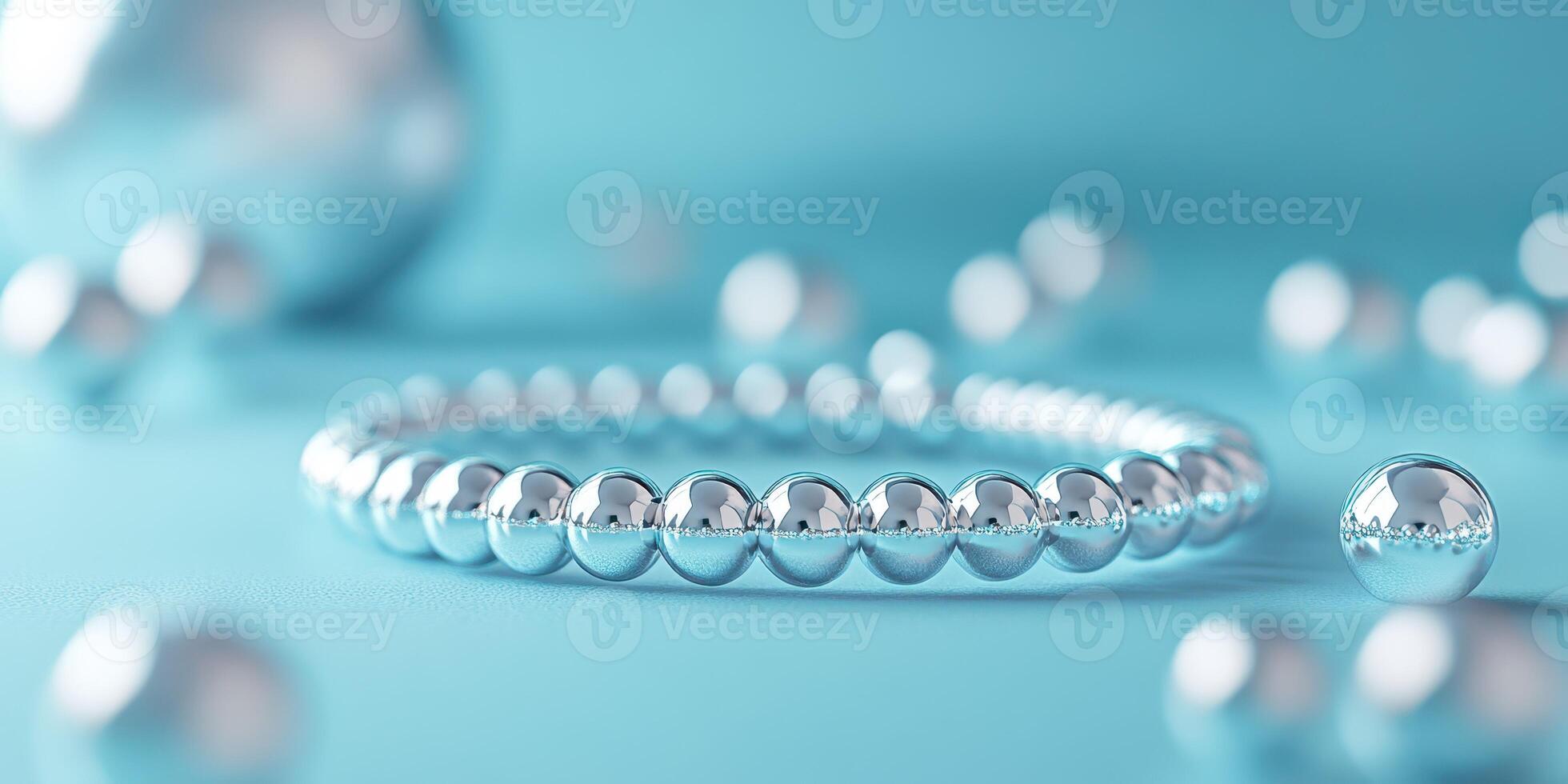 Shiny metallic beads arranged on a soft blue surface creating an elegant jewelry display just in time for a special occasion photo