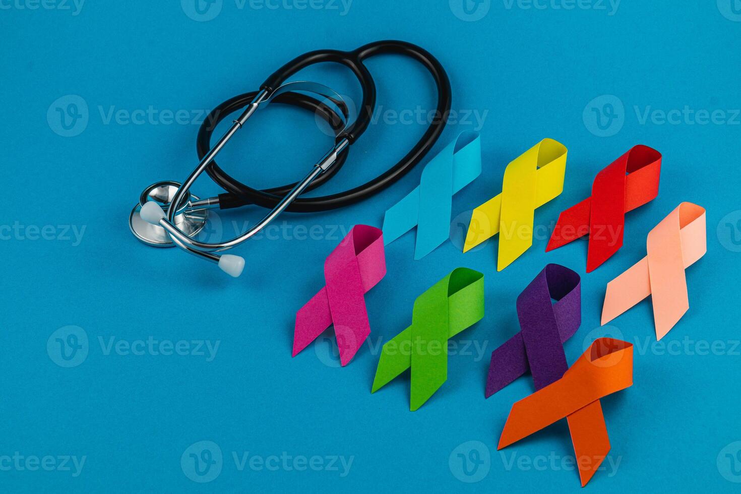 Colorful awareness ribbons alongside a stethoscope symbolizing health advocacy photo