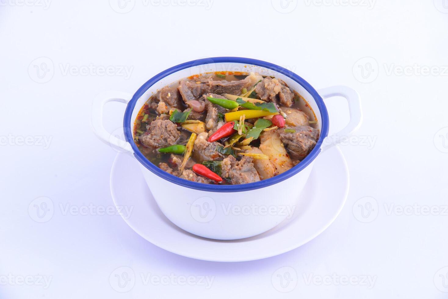 Thai favorite food. The spicy chicken soup in the white bowl. photo